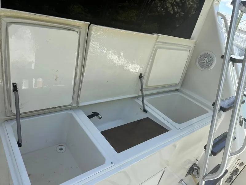 Slide: The Image of Viking 38 Convertible 1990 boat with open storage compartments on deck. - 3