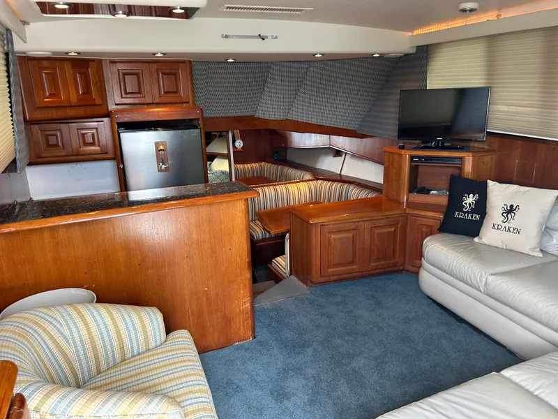 Slide: The Image of Interior of 1990 Viking 38 Convertible yacht with wood cabinetry and cozy seating area. - 4