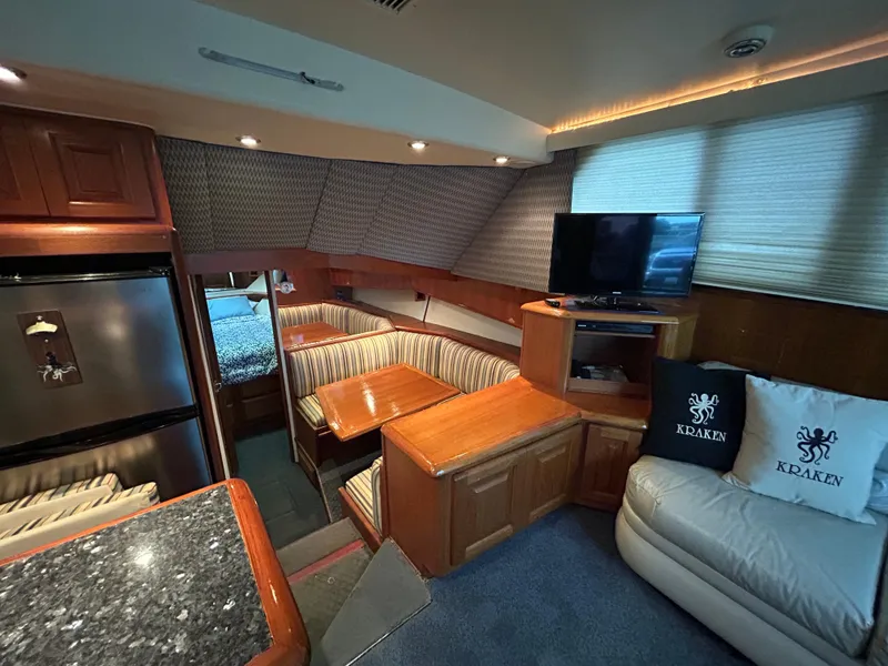 Slide: The Image of Luxurious interior of a 1990 Viking 38 Convertible yacht with cozy seating and modern amenities. - 6