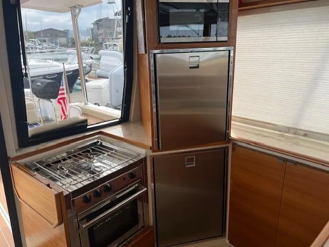 Slide: The Image of Interior of 2019 Ranger Tugs R-41 CB yacht kitchen with stove and stainless steel appliances. - 11