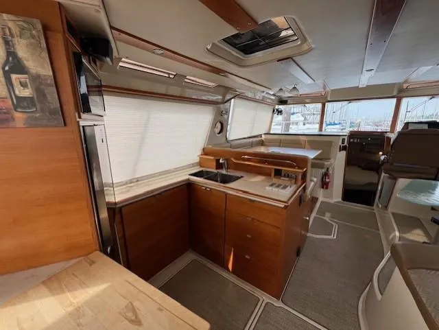 Slide: The Image of Interior of 2019 Ranger Tugs R-41 CB, featuring a modern kitchen and spacious layout. - 12