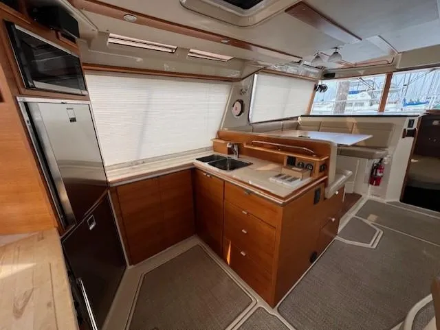 Slide: The Image of Interior of 2019 Ranger Tugs R-41 CB, featuring modern kitchen and dining area. - 13