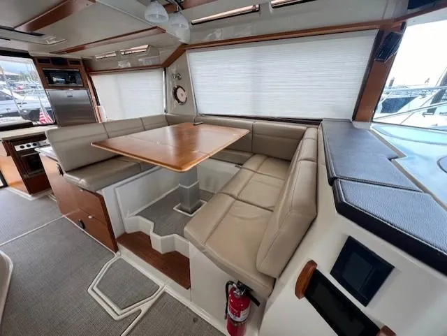 Slide: The Image of 2019 Ranger Tugs R-41 CB interior with dining area and beige seating. - 18