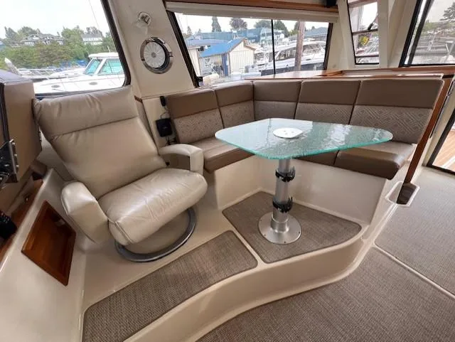 Slide: The Image of 2019 Ranger Tugs R-41 CB interior with leather seating and glass table. - 19
