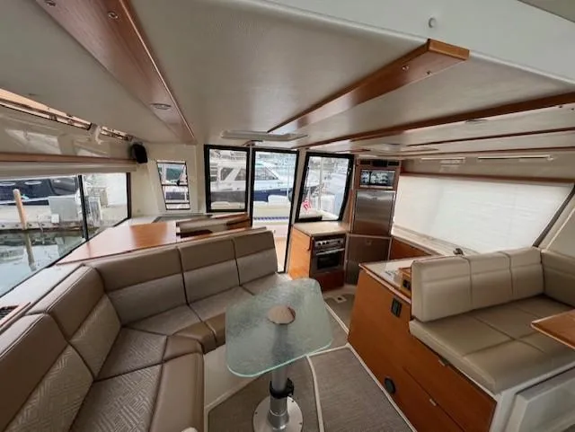 Slide: The Image of Interior of 2019 Ranger Tugs R-41 CB, featuring modern seating and a glass table. - 20