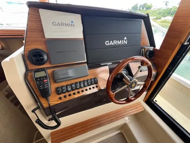 Slide: The Image of 2019 Ranger Tugs R-41 CB helm with Garmin navigation system and wooden steering wheel. - 24