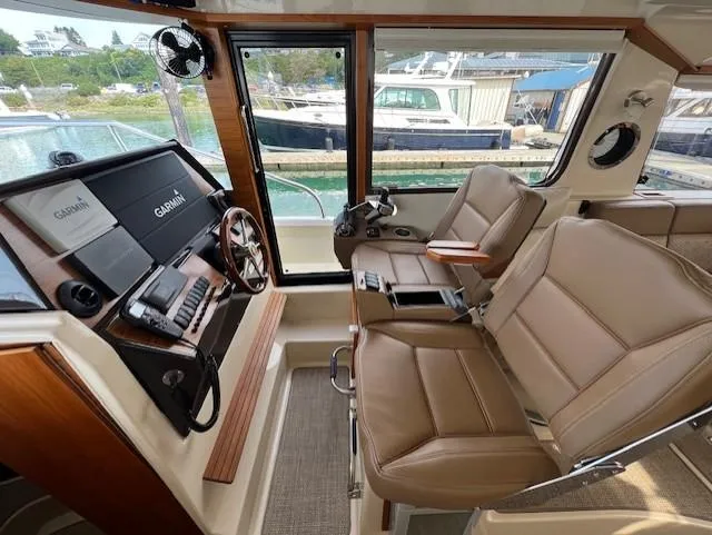 Slide: The Image of Interior of 2019 Ranger Tugs R-41 CB with leather seats and navigation equipment. - 25