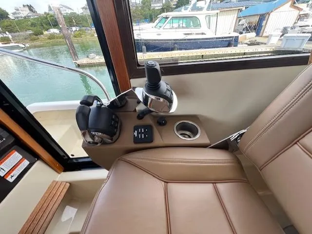 Slide: The Image of 2019 Ranger Tugs R-41 CB helm station with controls and leather seating. - 26