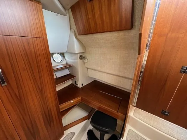 Slide: The Image of 2019 Ranger Tugs R-41 CB cabin interior with wooden finish and compact design. - 33