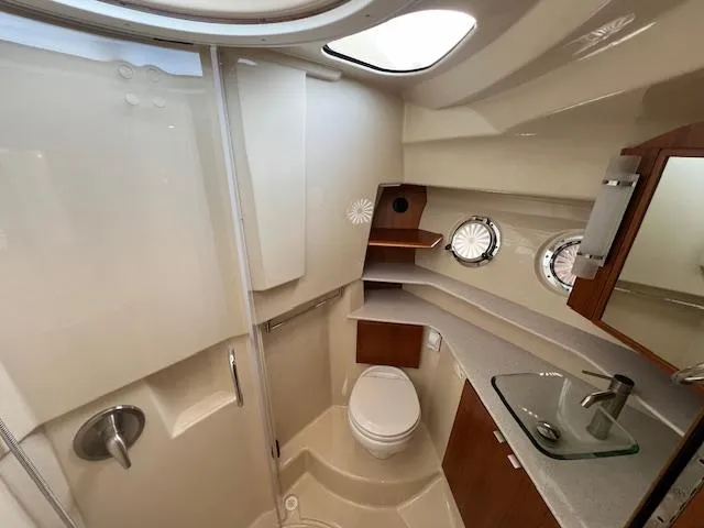 Slide: The Image of 2019 Ranger Tugs R-41 CB bathroom with modern fixtures and porthole windows. - 36
