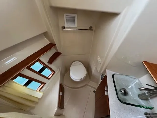 Slide: The Image of 2019 Ranger Tugs R-41 CB bathroom with toilet, sink, and window. - 39