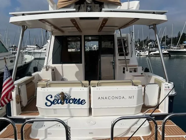 Slide: The Image of 2019 Ranger Tugs R-41 CB boat named "Seahorse" docked in a marina. - 4