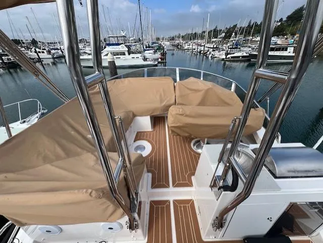 Slide: The Image of 2019 Ranger Tugs R-41 CB boat deck with covered seating, docked in a marina. - 42