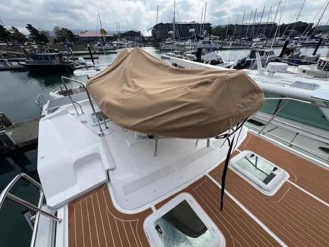 Slide: The Image of 2019 Ranger Tugs R-41 CB yacht with covered seating area, docked in marina. - 46