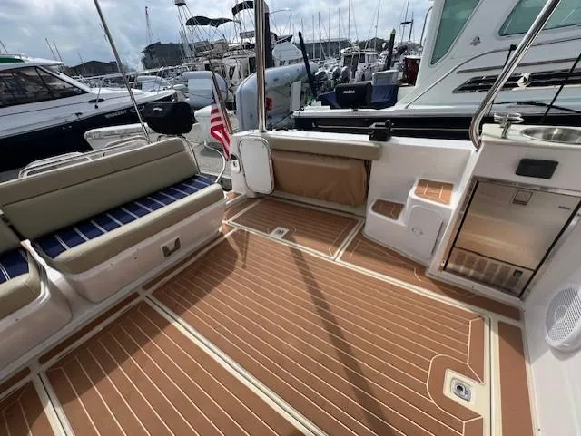 Slide: The Image of 2019 Ranger Tugs R-41 CB boat deck with seating and wood flooring at marina. - 5