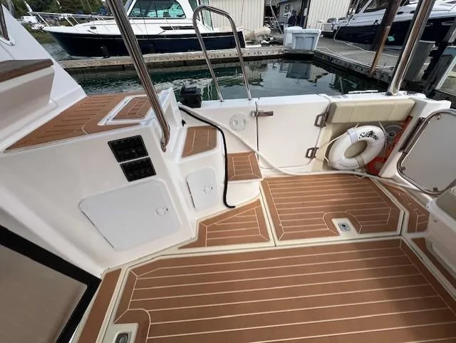 Slide: The Image of 2019 Ranger Tugs R-41 CB boat deck with wood finish and safety equipment. - 6