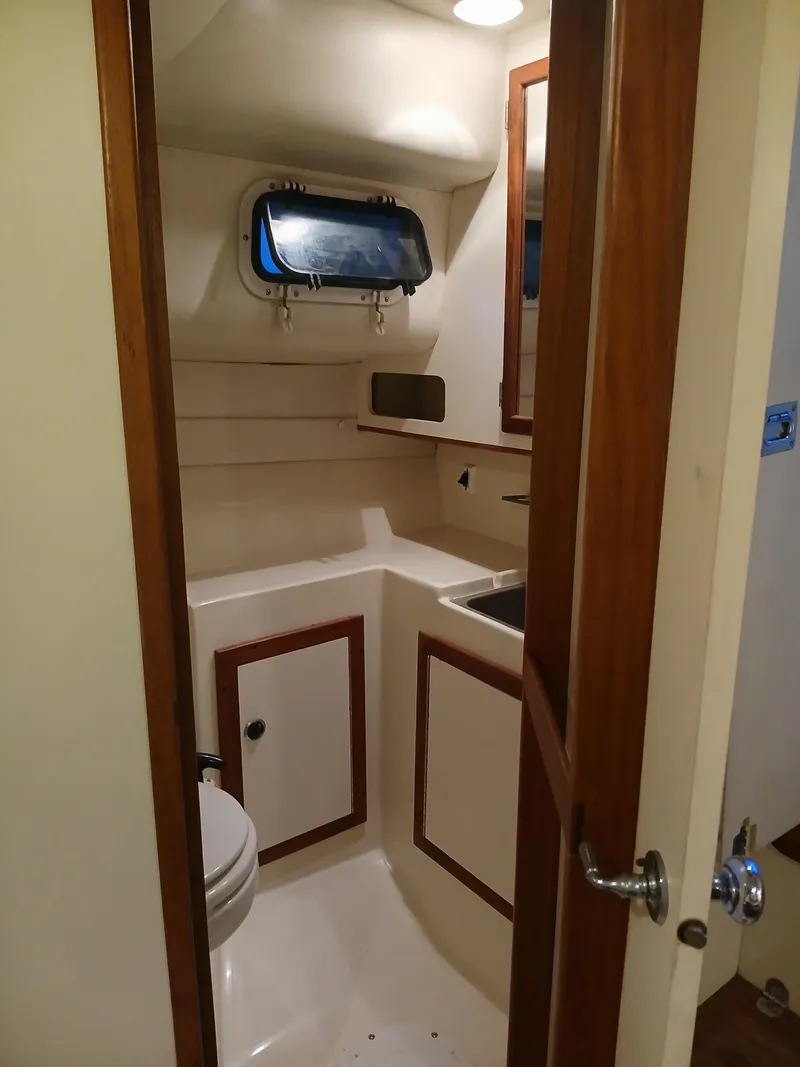 Slide: The Image of 1995 Albin 28 Tournament Express boat bathroom with sink and toilet. - 4