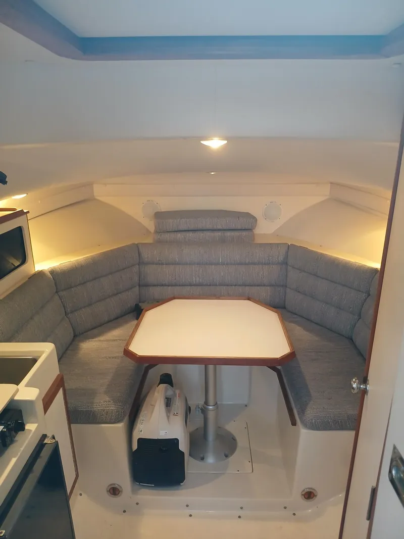 Slide: The Image of Interior of 1995 Albin 28 Tournament Express with cozy seating and table. - 5