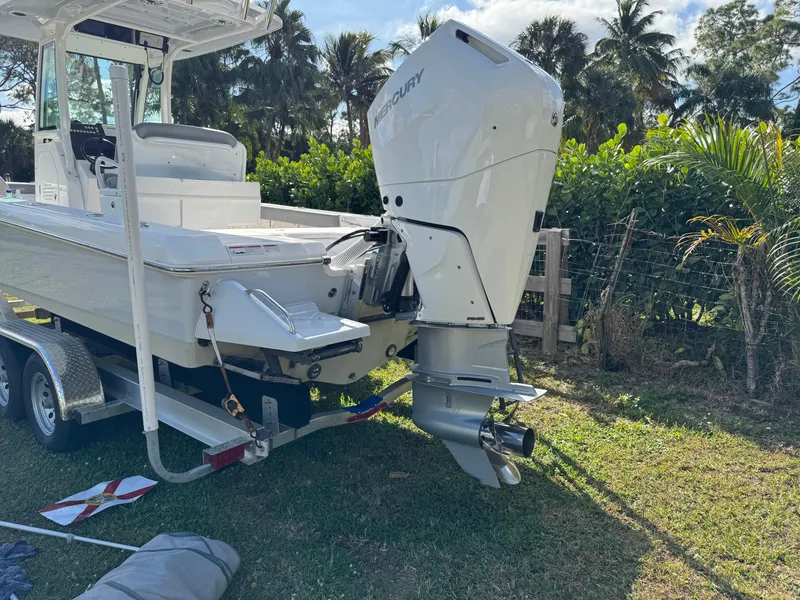 Slide: The Image of 2024 Everglades 253 Center Console boat on trailer, surrounded by lush greenery. - 10