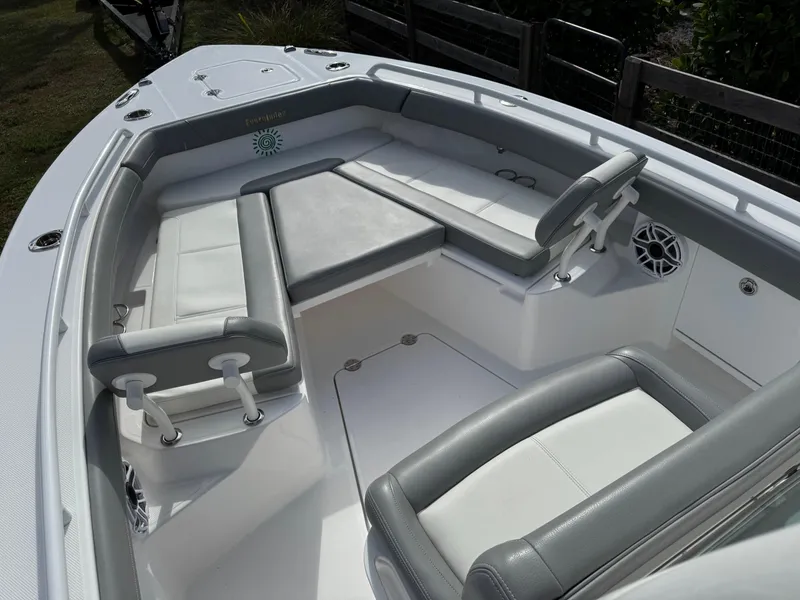 Slide: The Image of 2024 Everglades 253 Center Console boat interior with cushioned seating and modern design. - 12