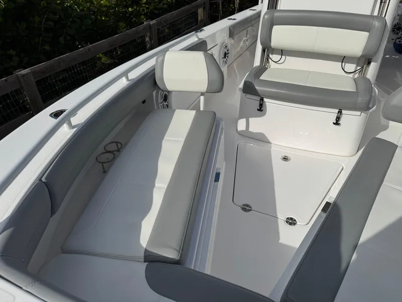 Slide: The Image of 2024 Everglades 253 Center Console boat interior with white seating and storage. - 15