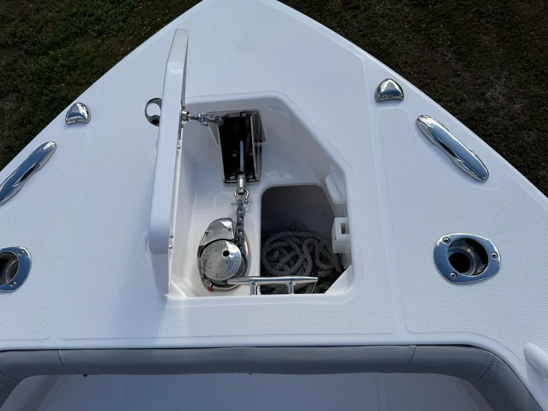 Slide: The Image of 2024 Everglades 253 Center Console boat anchor compartment with rope and fittings. - 17
