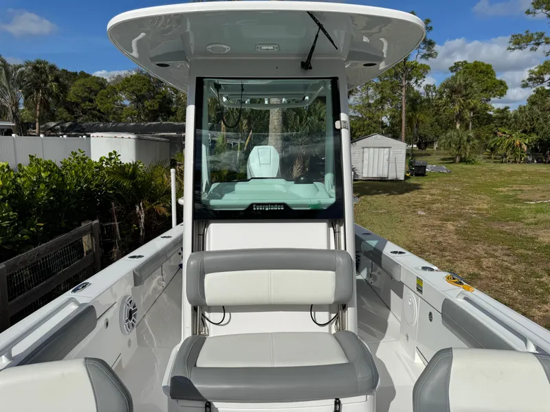 Slide: The Image of 2024 Everglades 253 Center Console boat with seating, parked outdoors. - 19