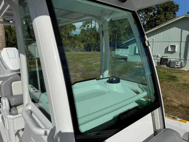 Slide: The Image of 2024 Everglades 253 Center Console boat with glass windshield and outdoor background. - 20