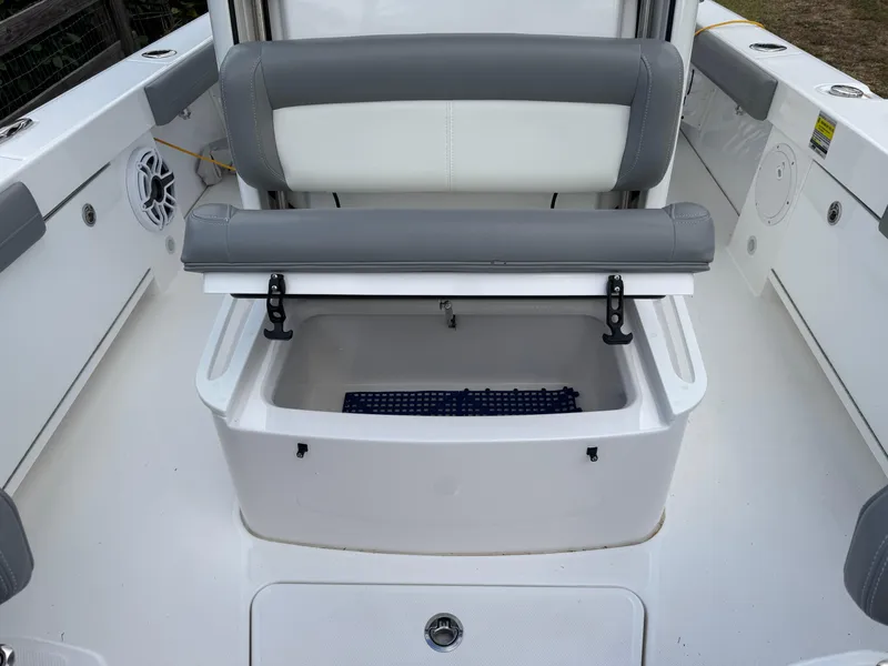 Slide: The Image of 2024 Everglades 253 Center Console boat interior with storage compartment and seating. - 23