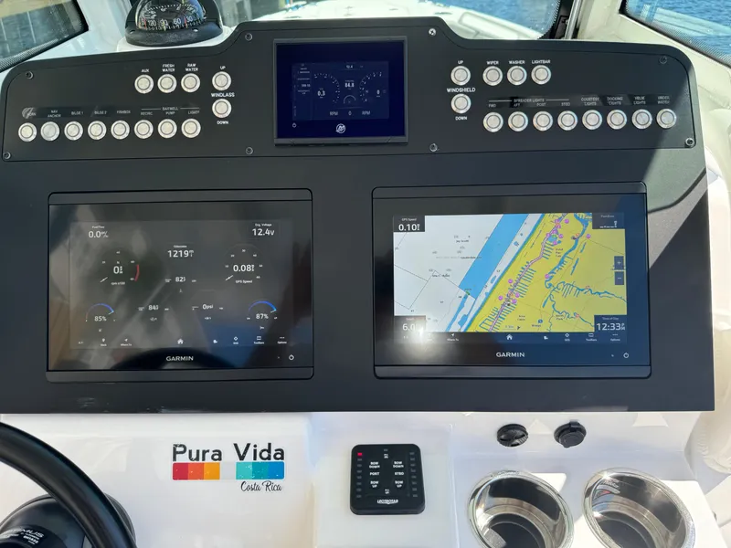Slide: The Image of 2024 Everglades 253 Center Console dashboard with navigation and control panels. - 26