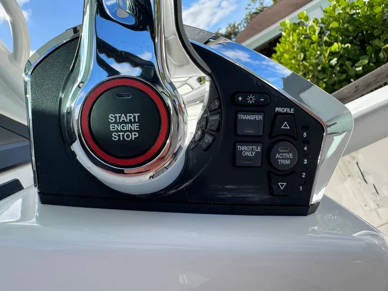 Slide: The Image of 2024 Everglades 253 Center Console engine control panel with start/stop button and trim settings. - 27