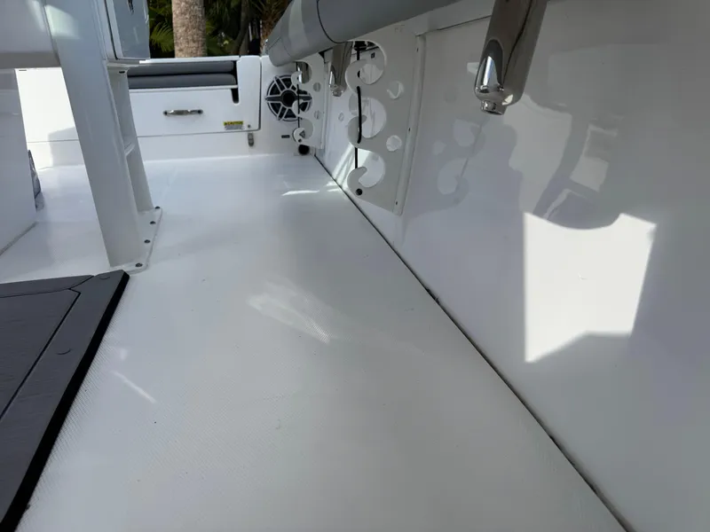 Slide: The Image of 2024 Everglades 253 Center Console boat interior with white deck and seating. - 34