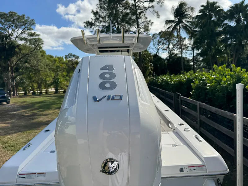 Slide: The Image of 2024 Everglades 253 Center Console boat with 400 V10 engine, outdoors. - 4