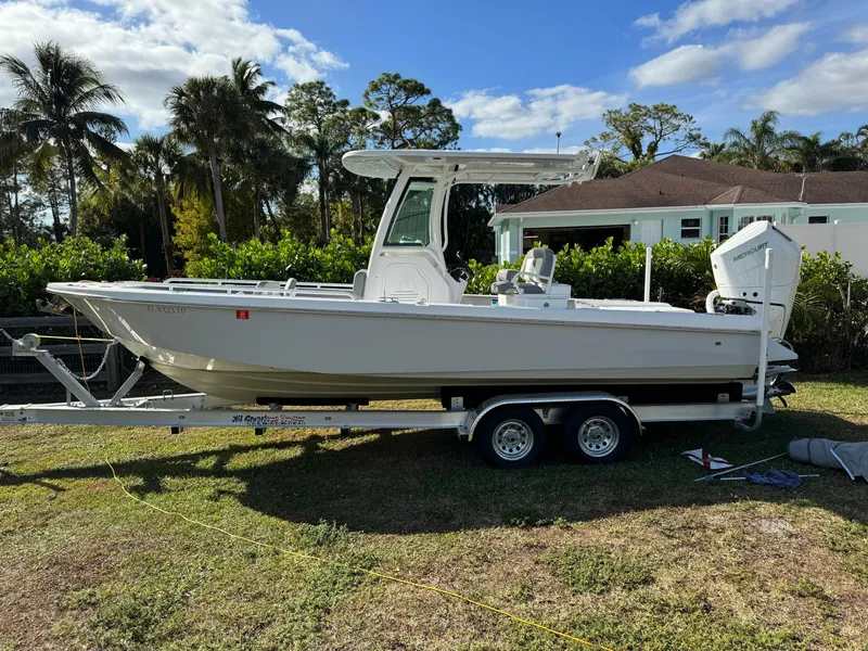 Slide: The Image of 2024 Everglades 253 Center Console boat on trailer, parked outdoors. - 5