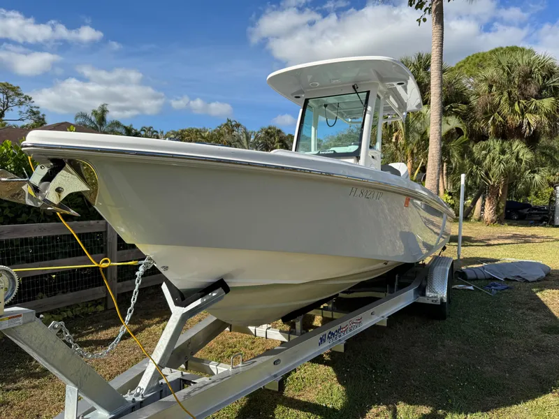 Slide: The Image of 2024 Everglades 253 Center Console boat on trailer, surrounded by palm trees. - 6