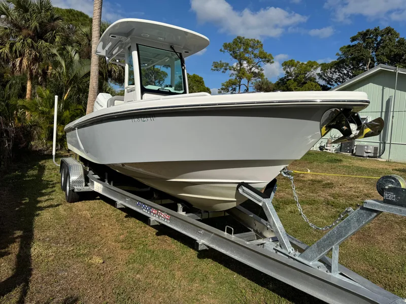 Slide: The Image of 2024 Everglades 253 Center Console boat on trailer, parked outdoors. - 7