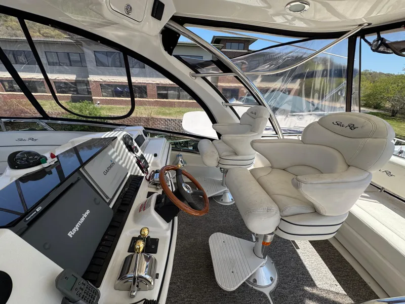 Slide: The Image of 2005 Sea Ray 500 Sedan Bridge helm with luxurious seating and advanced navigation equipment. - 10
