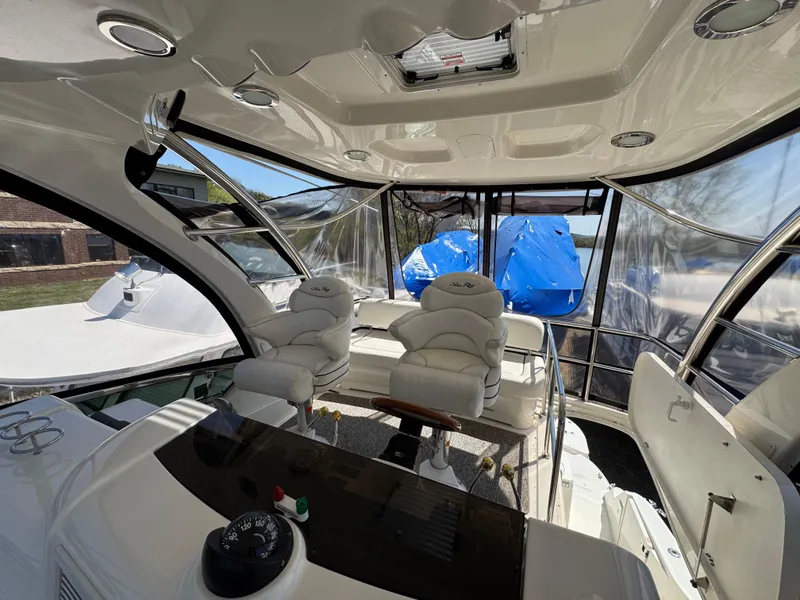 Slide: The Image of 2005 Sea Ray 500 Sedan Bridge interior with helm and seating area. - 11