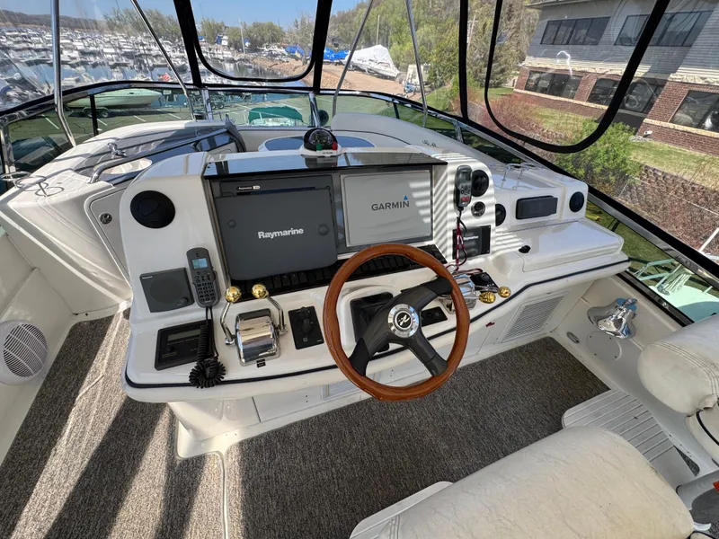 Slide: The Image of 2005 Sea Ray 500 Sedan Bridge helm with Garmin and Raymarine navigation systems. - 16