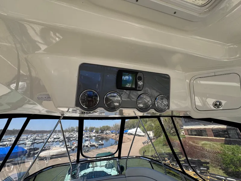 Slide: The Image of 2005 Sea Ray 500 Sedan Bridge helm with gauges and marina view. - 19