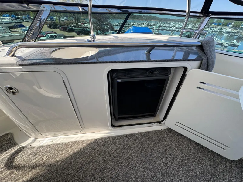 Slide: The Image of 2005 Sea Ray 500 Sedan Bridge yacht interior with open cabinet and mini fridge. - 24