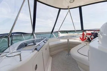 Slide: The Image of 2005 Sea Ray 500 Sedan Bridge interior with seating, table, and nautical decor. - 26