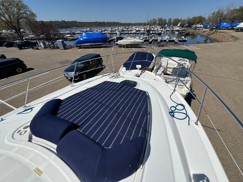 Slide: The Image of 2005 Sea Ray 500 Sedan Bridge yacht docked at marina with sun pad and scenic view. - 27