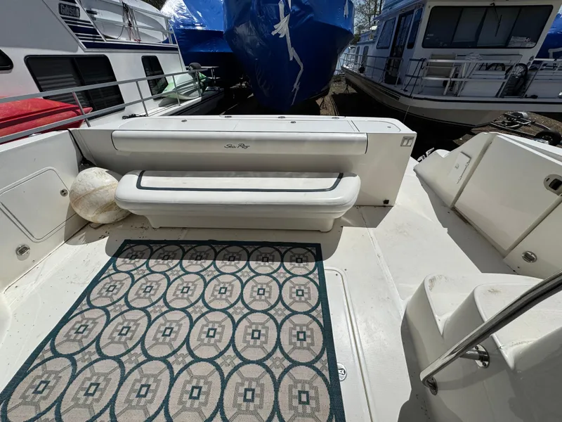 Slide: The Image of 2005 Sea Ray 500 Sedan Bridge deck with patterned rug and seating. - 34
