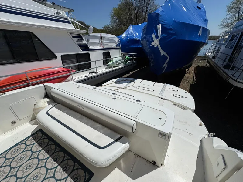 Slide: The Image of 2005 Sea Ray 500 Sedan Bridge Fresh Water yacht docked with covered boats nearby. - 35
