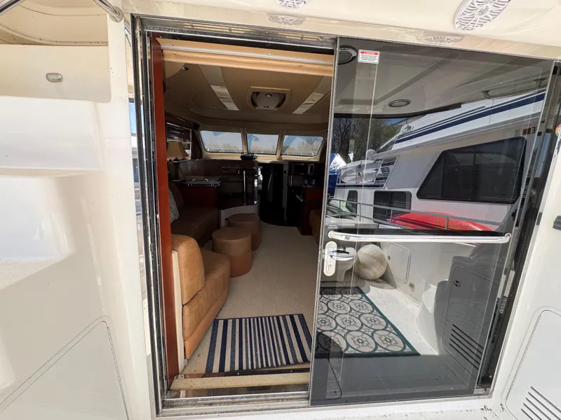 Slide: The Image of 2005 Sea Ray 500 Sedan Bridge yacht interior view through glass door. - 36