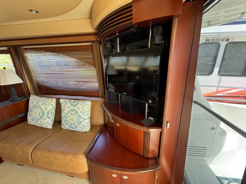 Slide: The Image of Luxurious interior of 2005 Sea Ray 500 Sedan Bridge yacht with TV and sofa. - 39
