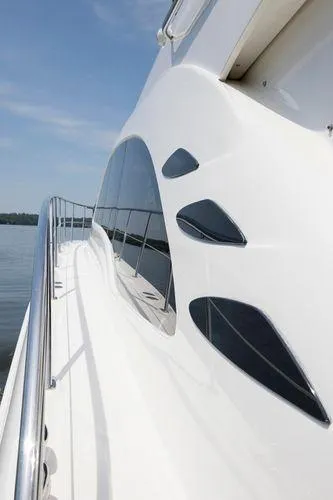 Slide: The Image of 2005 Sea Ray 500 Sedan Bridge yacht, sleek design, side view on calm water. - 4