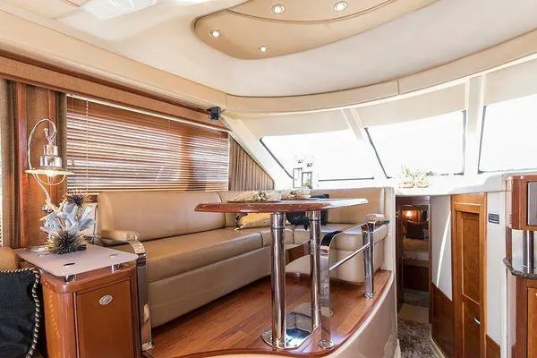 Slide: The Image of Luxurious interior of 2005 Sea Ray 500 Sedan Bridge yacht with elegant seating and table. - 42
