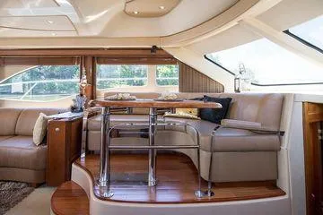 Slide: The Image of Luxurious interior of 2005 Sea Ray 500 Sedan Bridge yacht with elegant seating and dining area. - 44